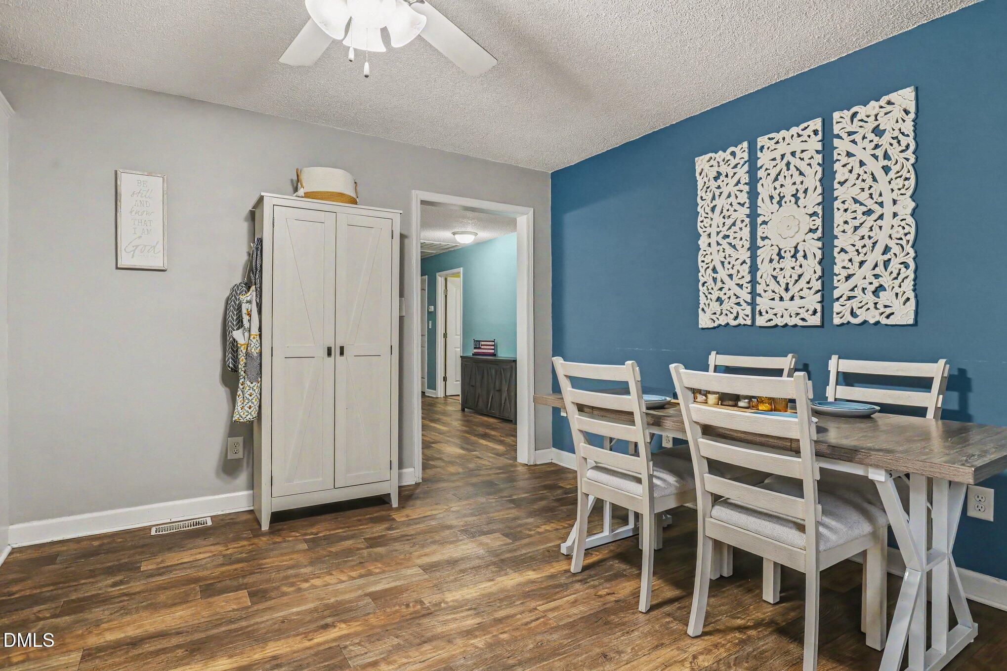 977 Stevens Mill Road Goldsboro, NC 27530 - Photo 11 of 31 a view of a dining room with furniture and wooden floor