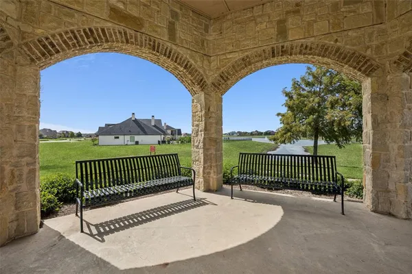a view of balcony with wooden floor and fence