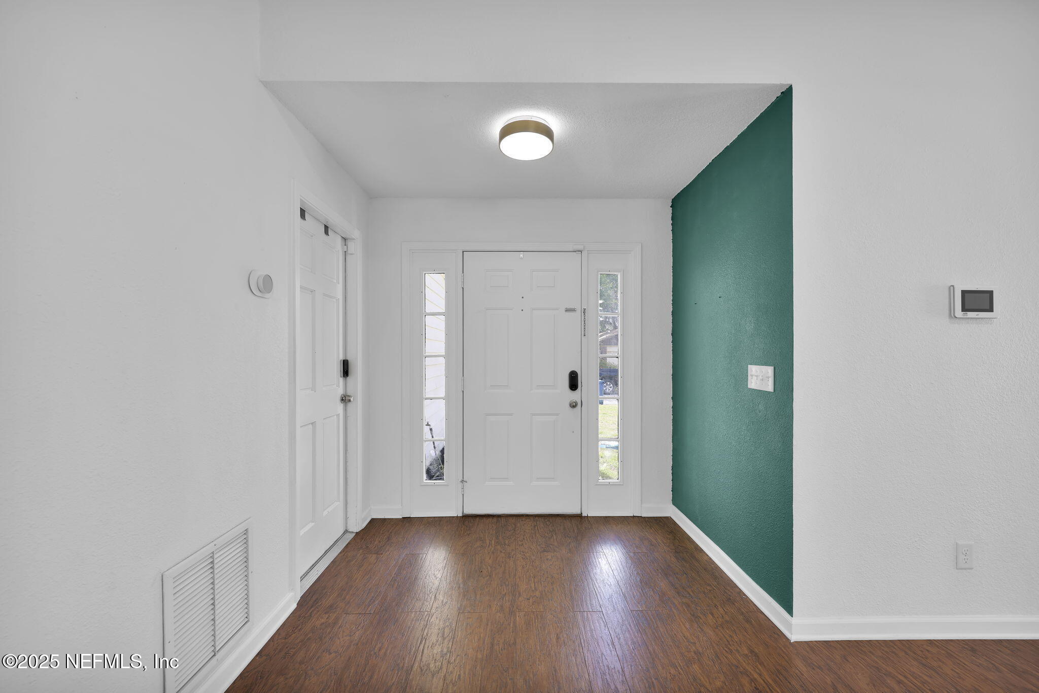 5455 Spring Brook Road Jacksonville, FL 32277 - Photo 4 of 21 a view of an empty room with wooden floor and closet