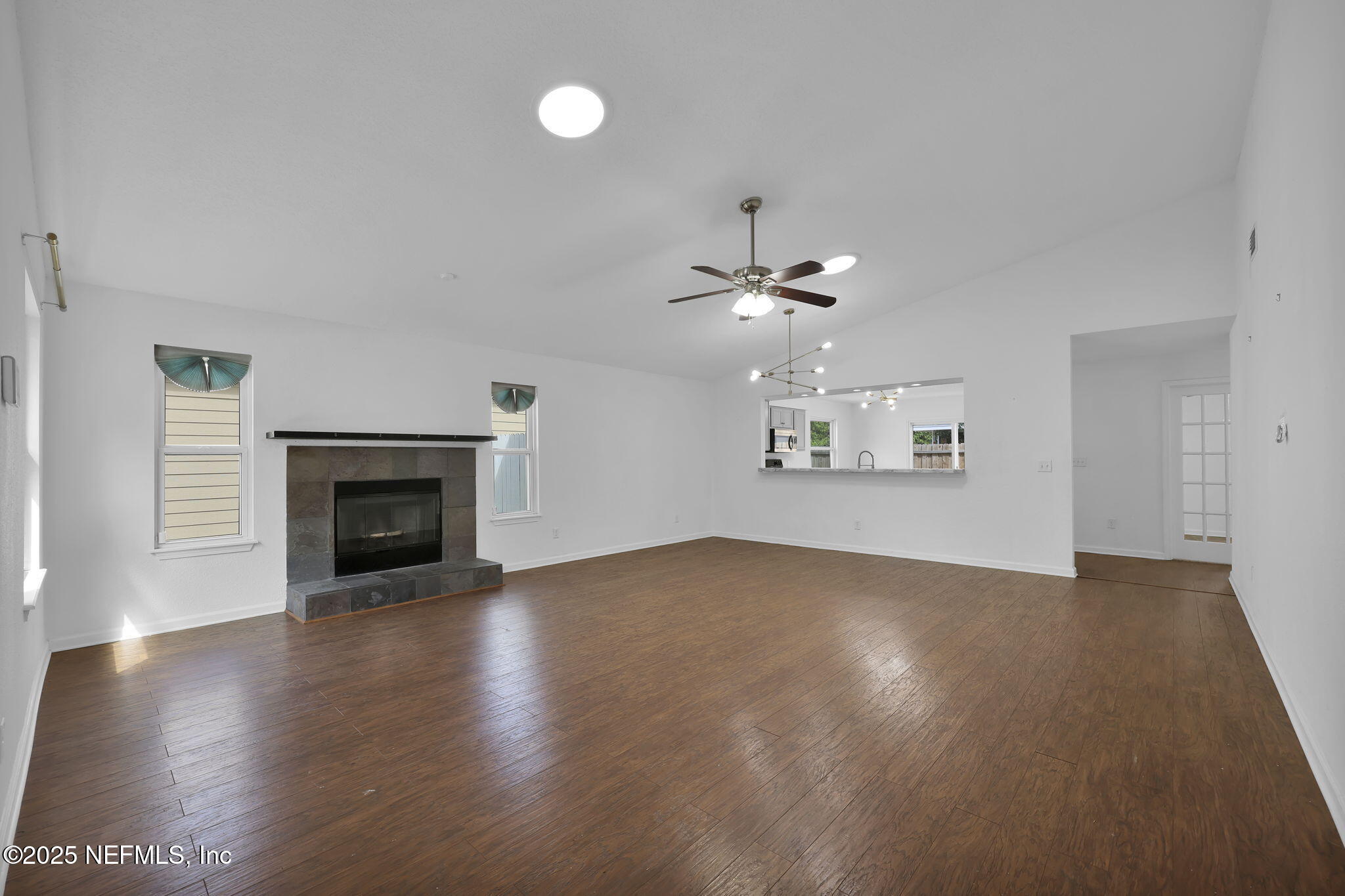 5455 Spring Brook Road Jacksonville, FL 32277 - Photo 5 of 21 an empty room with windows and fireplace