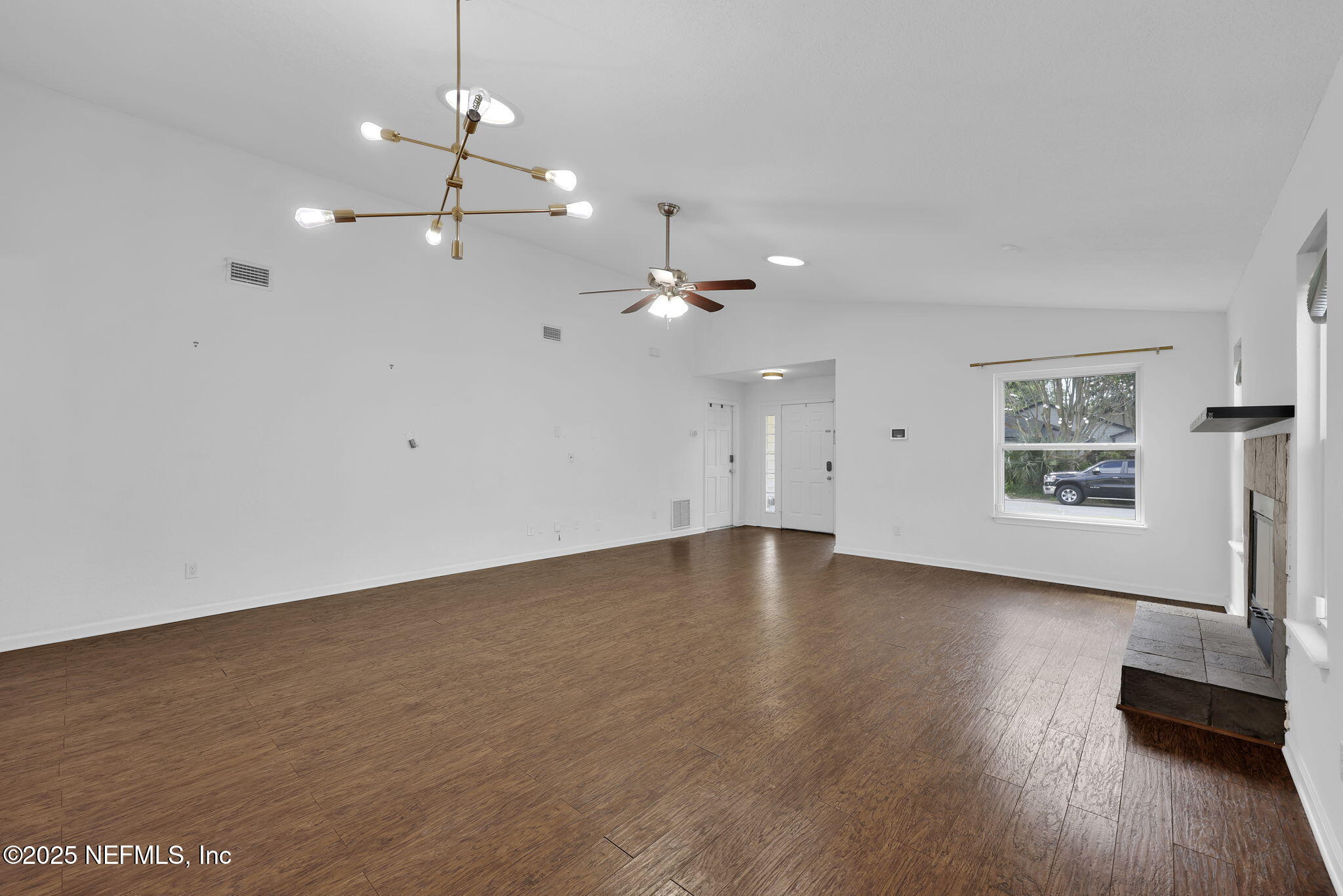 5455 Spring Brook Road Jacksonville, FL 32277 - Photo 6 of 21 a view of an empty room with wooden floor and a ceiling fan