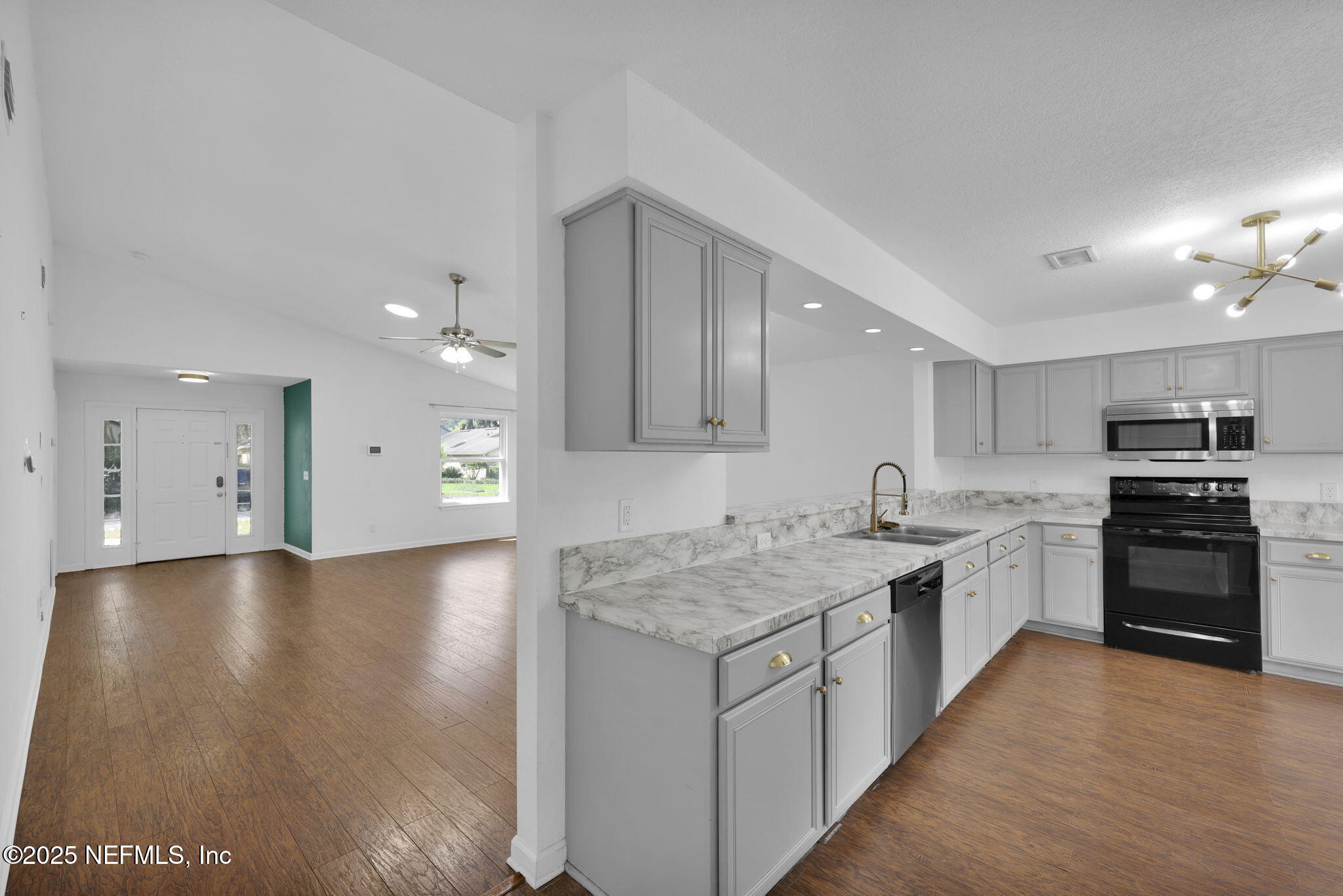 5455 Spring Brook Road Jacksonville, FL 32277 - Photo 7 of 21 a kitchen with a stove top oven sink and cabinets