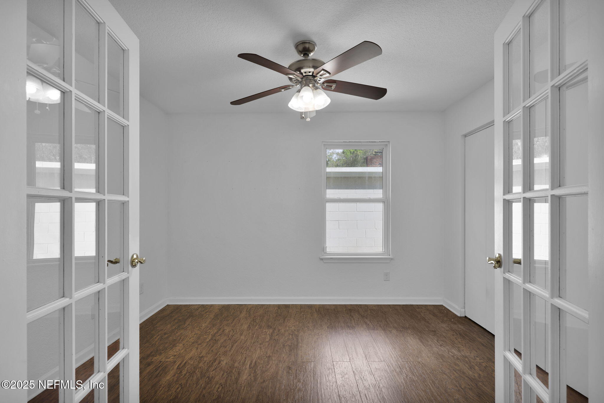 5455 Spring Brook Road Jacksonville, FL 32277 - Photo 10 of 21 a view of an empty room with wooden floor and a window