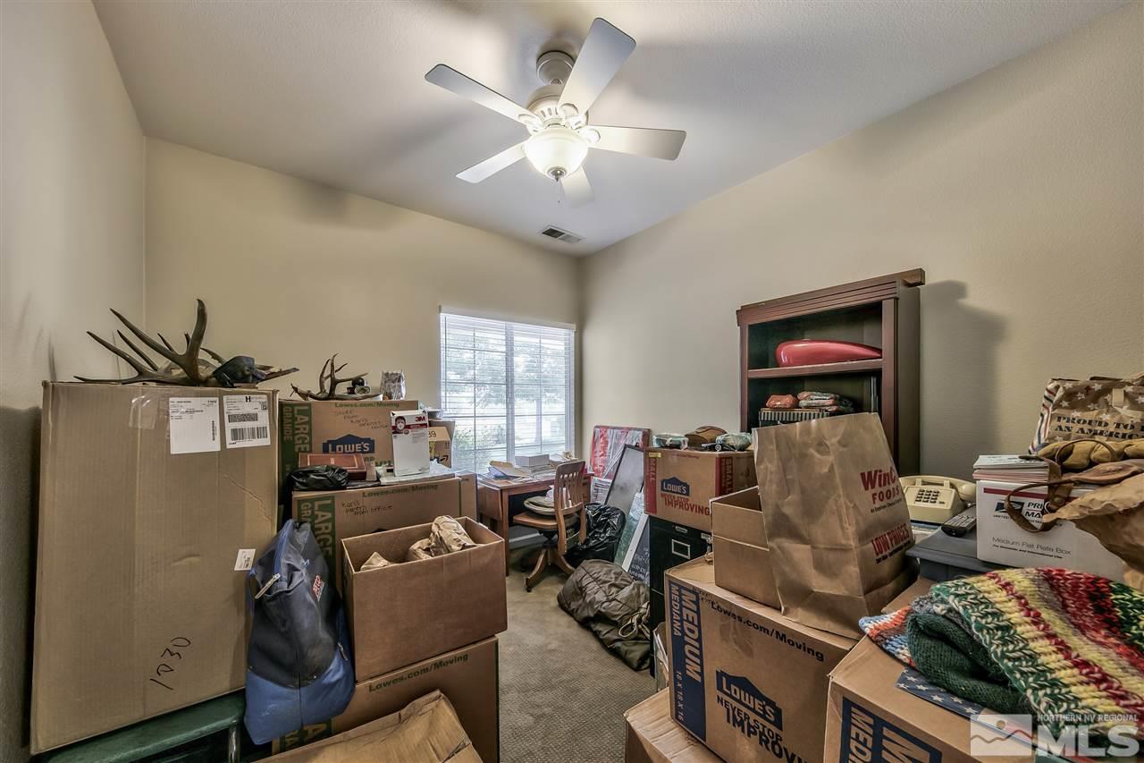 10680 Arbor Way Reno, NV 89521 - Photo 11 of 16 a room with furniture a chandelier and a window