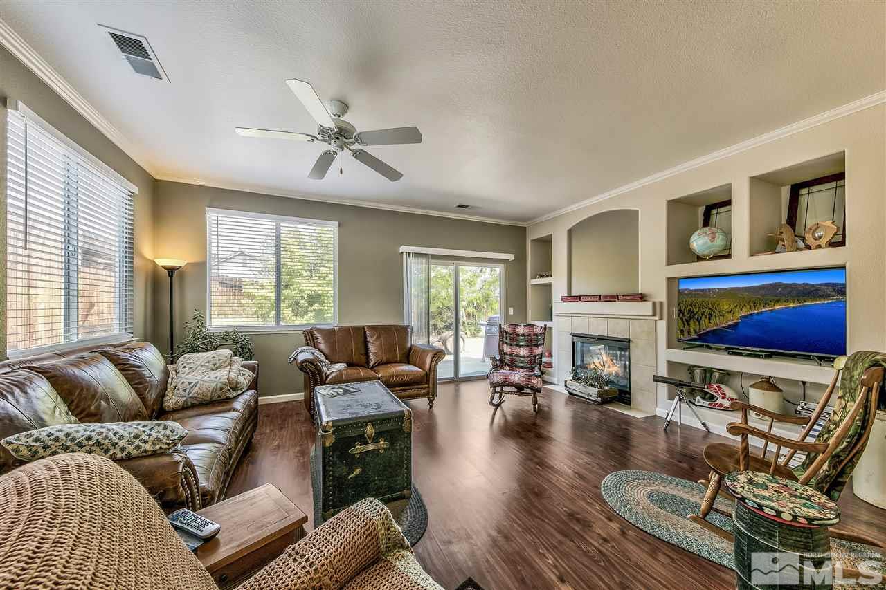 10680 Arbor Way Reno, NV 89521 - Photo 2 of 16 a living room with furniture a fireplace and a large window