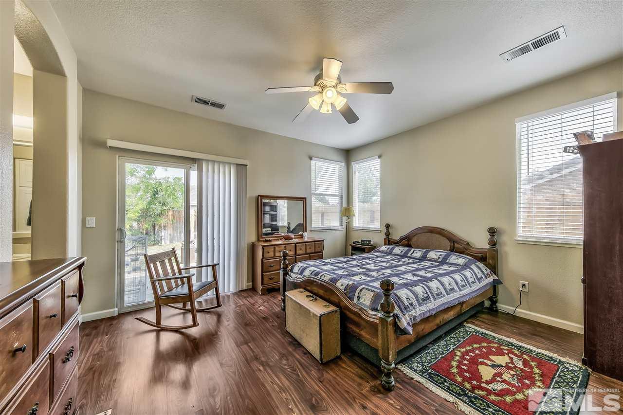 10680 Arbor Way Reno, NV 89521 - Photo 8 of 16 a bedroom with a bed and a chandelier