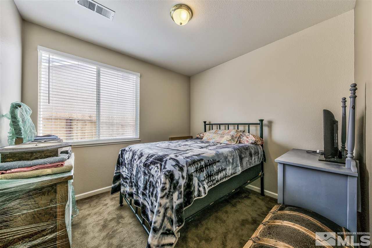 10680 Arbor Way Reno, NV 89521 - Photo 10 of 16 a bedroom with a bed and a window