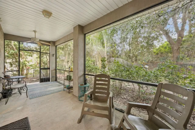 a view of a street with a flower plants and wooden fence