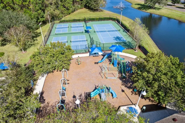 an aerial view of a house with swimming pool patio and lake view