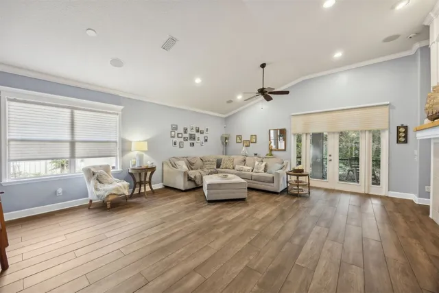 a living room with furniture and wooden floor