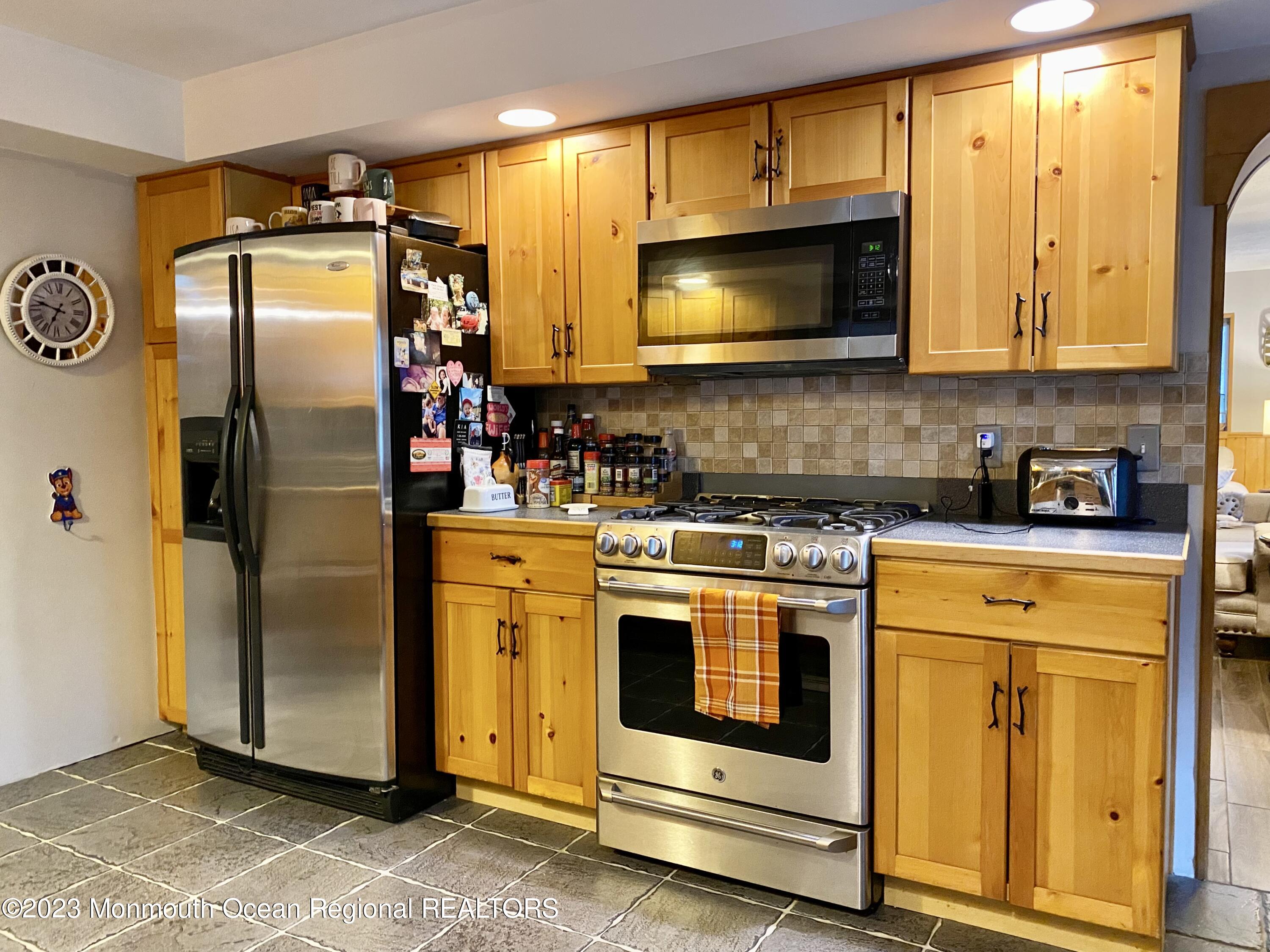 113 Maple Avenue Tuckerton, NJ 08087 - Photo 19 of 69 a kitchen with stainless steel appliances granite countertop a stove microwave and refrigerator