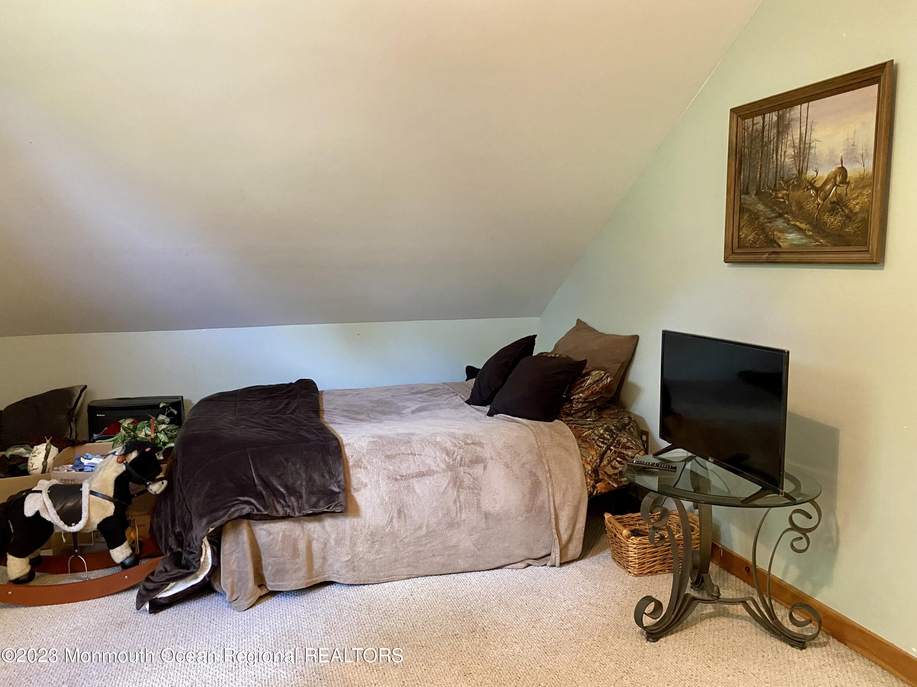 113 Maple Avenue Tuckerton, NJ 08087 - Photo 37 of 69 a bedroom with a bed and a chair