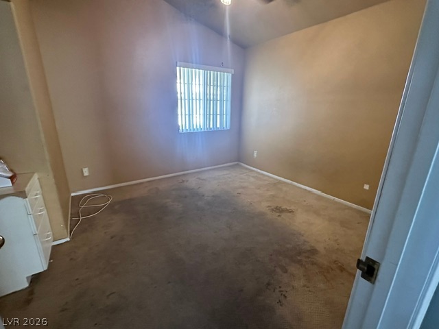 686 Skyline Road Henderson, NV 89002 - Photo 7 of 13 Vaulted ceilings elevate this classic bedroom with natural light streaming through the main window.