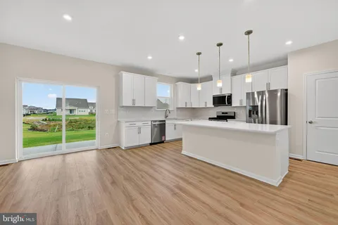 a kitchen with a sink chandelier and a stove