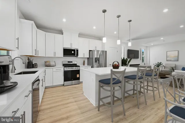 a large kitchen with granite countertop a stove top oven a sink a counter space and cabinets