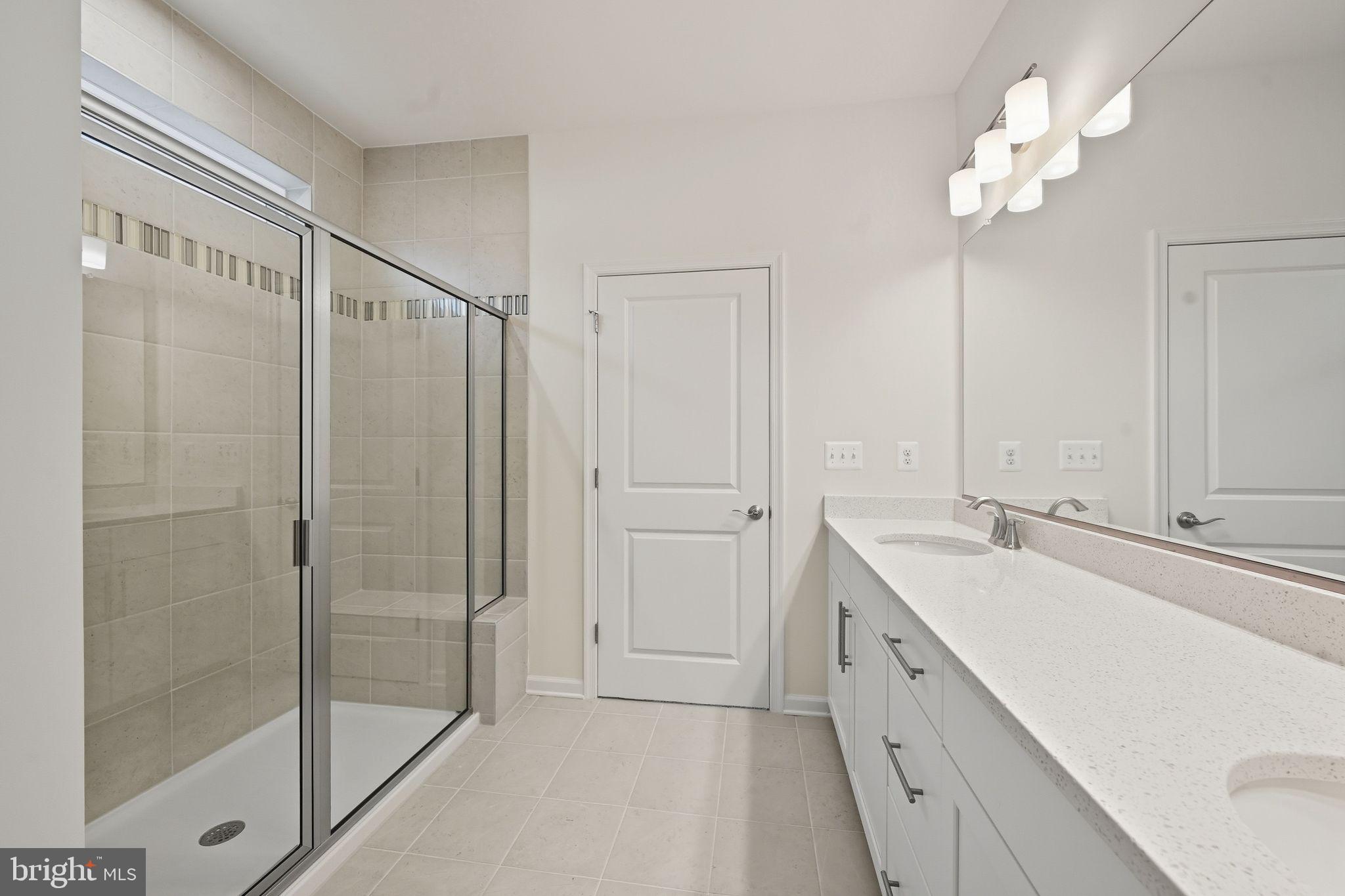 25013 Cypress Court Lewes, DE 19958 - Photo 20 of 24 a bathroom with a double vanity sink and a mirror