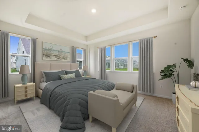 a bedroom with a large bed couch and a window