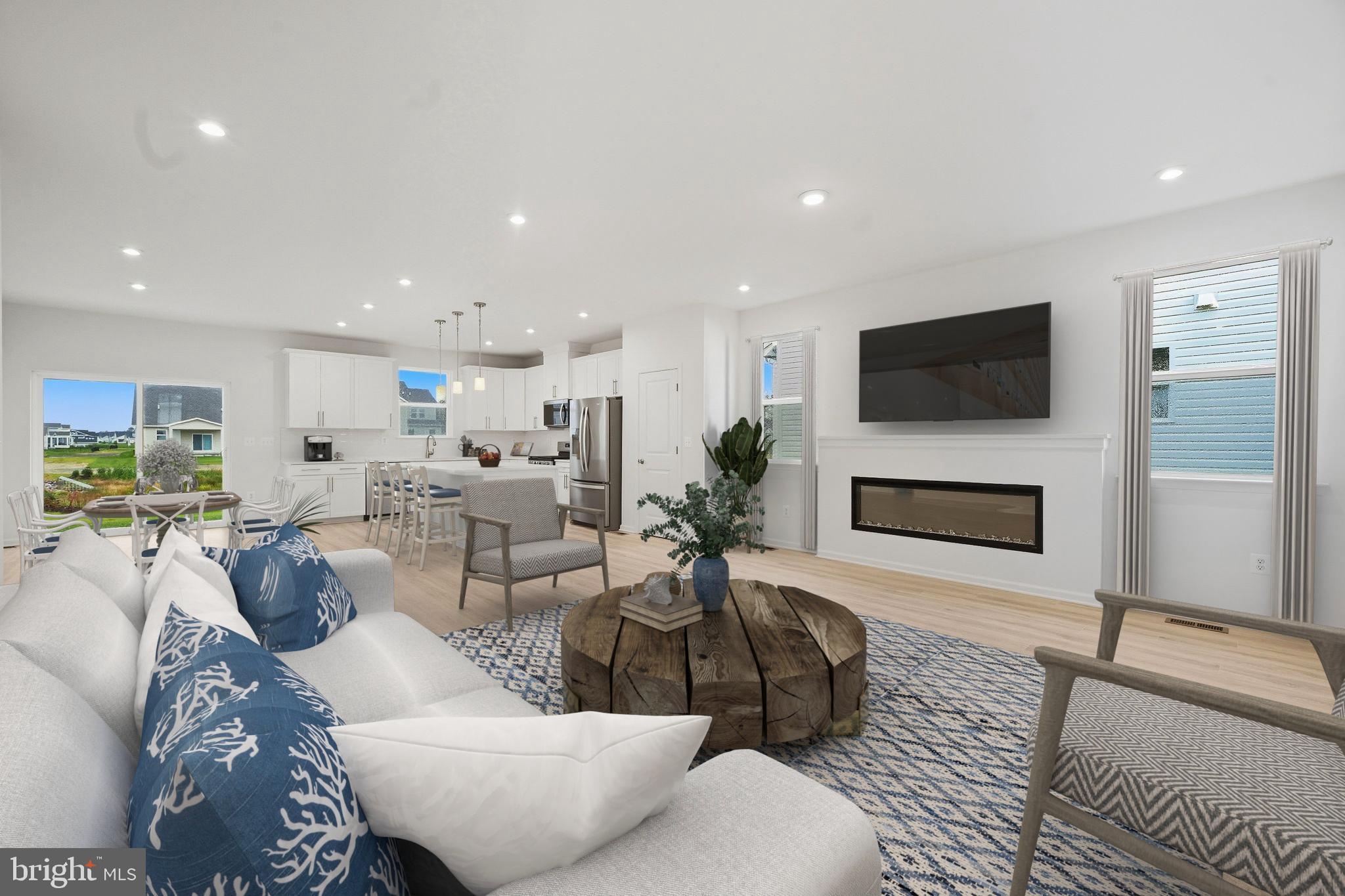 25013 Cypress Court Lewes, DE 19958 - Photo 7 of 24 a living room with furniture a fireplace and a flat screen tv