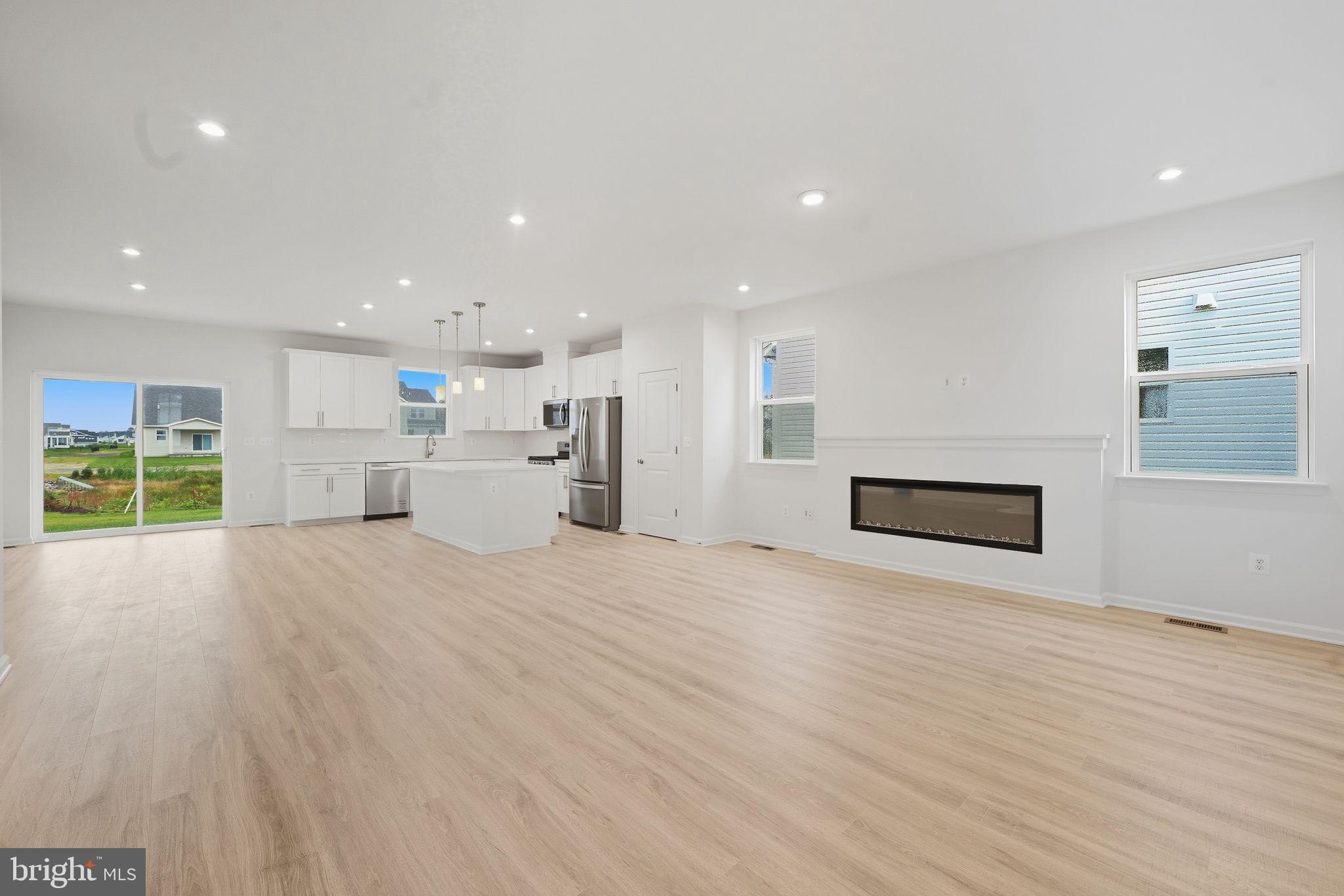 25013 Cypress Court Lewes, DE 19958 - Photo 8 of 24 a view of empty room with wooden floor and window
