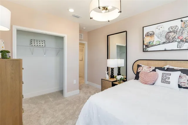 a bedroom with a large bed and a painting on the wall