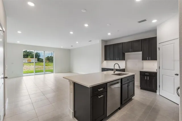 a kitchen with a sink a stove and a refrigerator