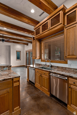 2464 East Granite Way St. George, UT 84790 - Photo 51 of 106 Kitchen with concrete flooring, dark stone counters, beamed ceiling, wood finish cabinetry, and dishwasher