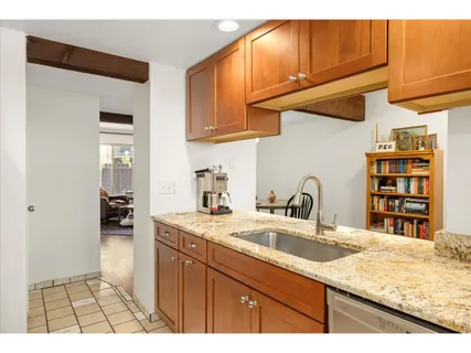 a kitchen with a sink a stove and cabinets