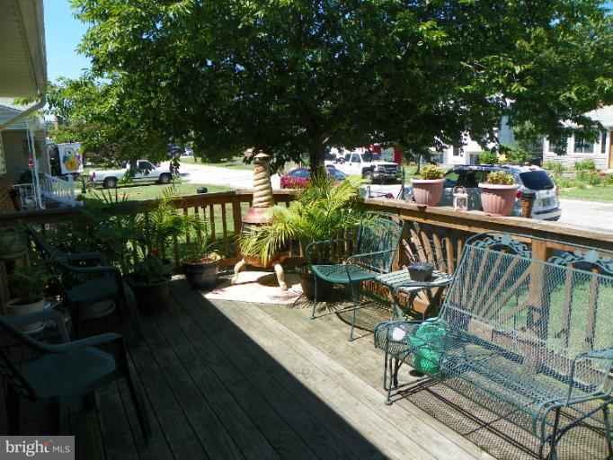 187 Inlet Drive Pasadena, MD 21122 - Photo 1 of 29 a view of a balcony with chairs and wooden floor
