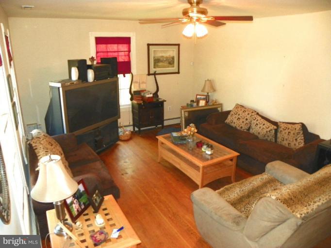 187 Inlet Drive Pasadena, MD 21122 - Photo 2 of 29 a living room with furniture and a flat screen tv