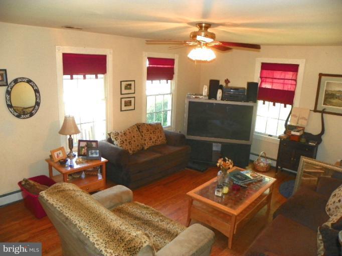 187 Inlet Drive Pasadena, MD 21122 - Photo 11 of 29 a living room with furniture and a flat screen tv