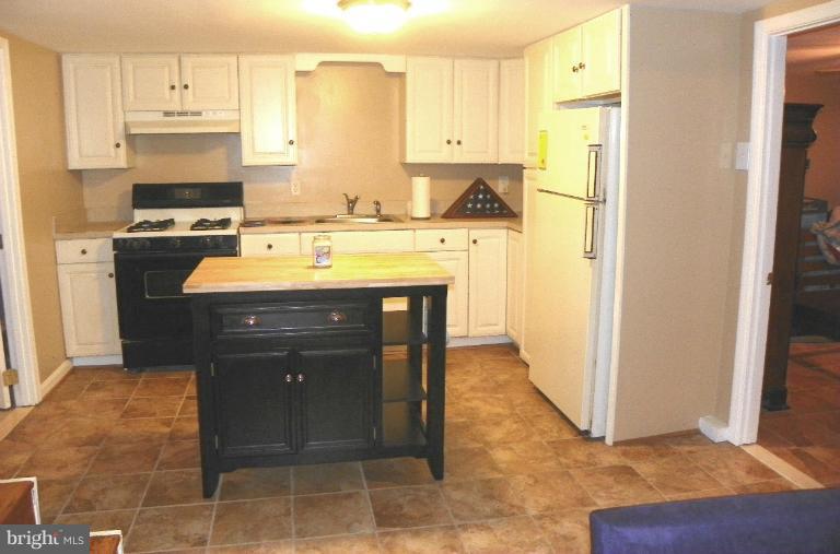 187 Inlet Drive Pasadena, MD 21122 - Photo 12 of 29 a kitchen with stainless steel appliances granite countertop a refrigerator a stove and a sink