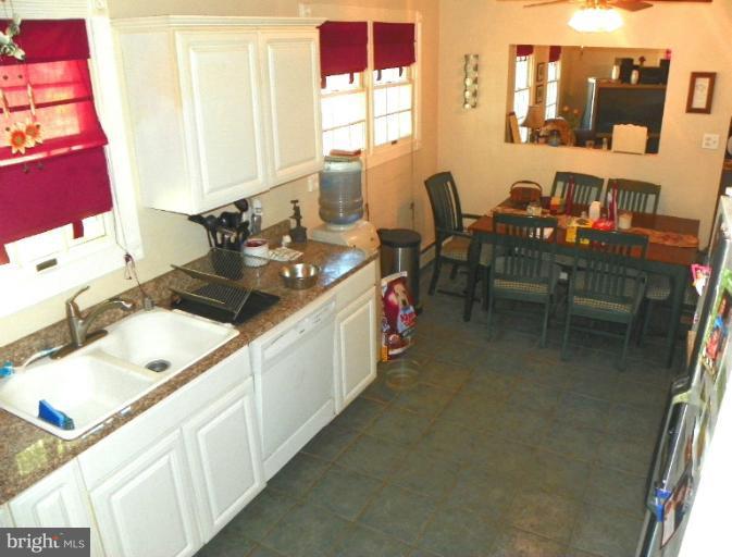 187 Inlet Drive Pasadena, MD 21122 - Photo 17 of 29 a kitchen with a sink stove and cabinets