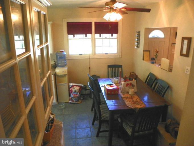 187 Inlet Drive Pasadena, MD 21122 - Photo 19 of 29 a view of a dining room with furniture and a chandelier