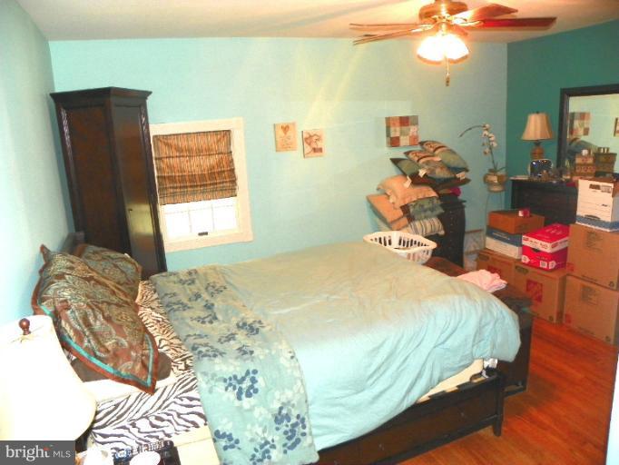 187 Inlet Drive Pasadena, MD 21122 - Photo 20 of 29 a bedroom with a bed and dresser with mirror