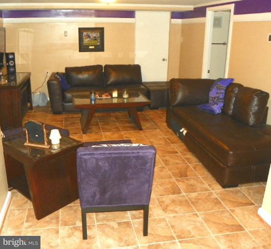 187 Inlet Drive Pasadena, MD 21122 - Photo 23 of 29 a living room with furniture and a flat screen tv