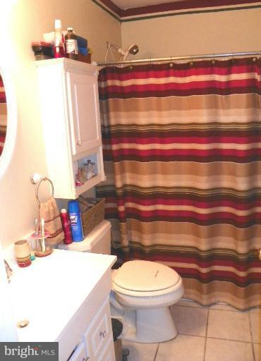 187 Inlet Drive Pasadena, MD 21122 - Photo 24 of 29 a bathroom with a toilet and a sink