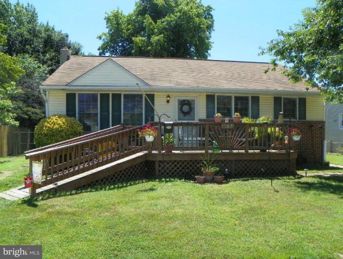 187 Inlet Drive Pasadena, MD 21122 - Photo 29 of 29 a front view of a house with a yard table and chairs
