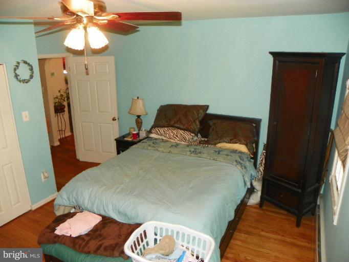 187 Inlet Drive Pasadena, MD 21122 - Photo 6 of 29 a bedroom with a bed and a chandelier