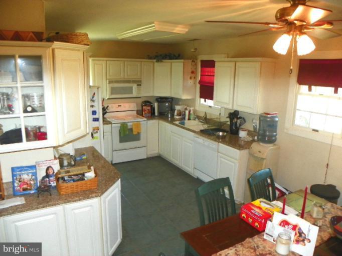 187 Inlet Drive Pasadena, MD 21122 - Photo 9 of 29 a kitchen with a sink stove and cabinets