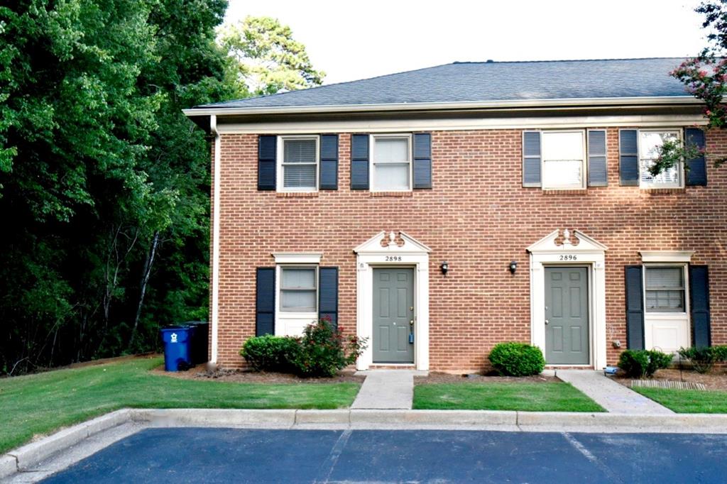 2898 Webb Bridge Road Alpharetta, GA 30009 - Photo 1 of 8 a front view of a house with yard and green space