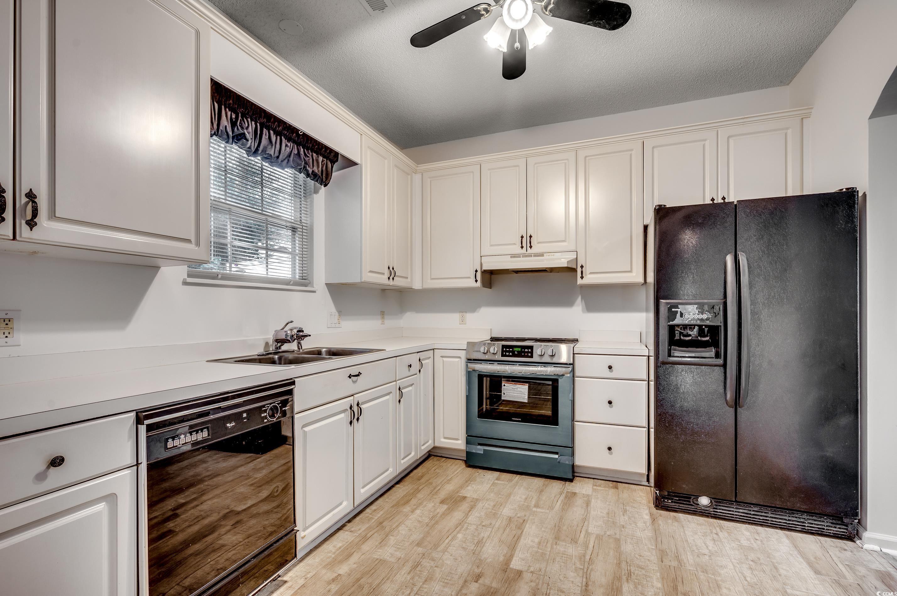 4261 Brook Drive Murrells Inlet, SC 29576 - Photo 11 of 39 Kitchen with white cabinets, black appliances, cei