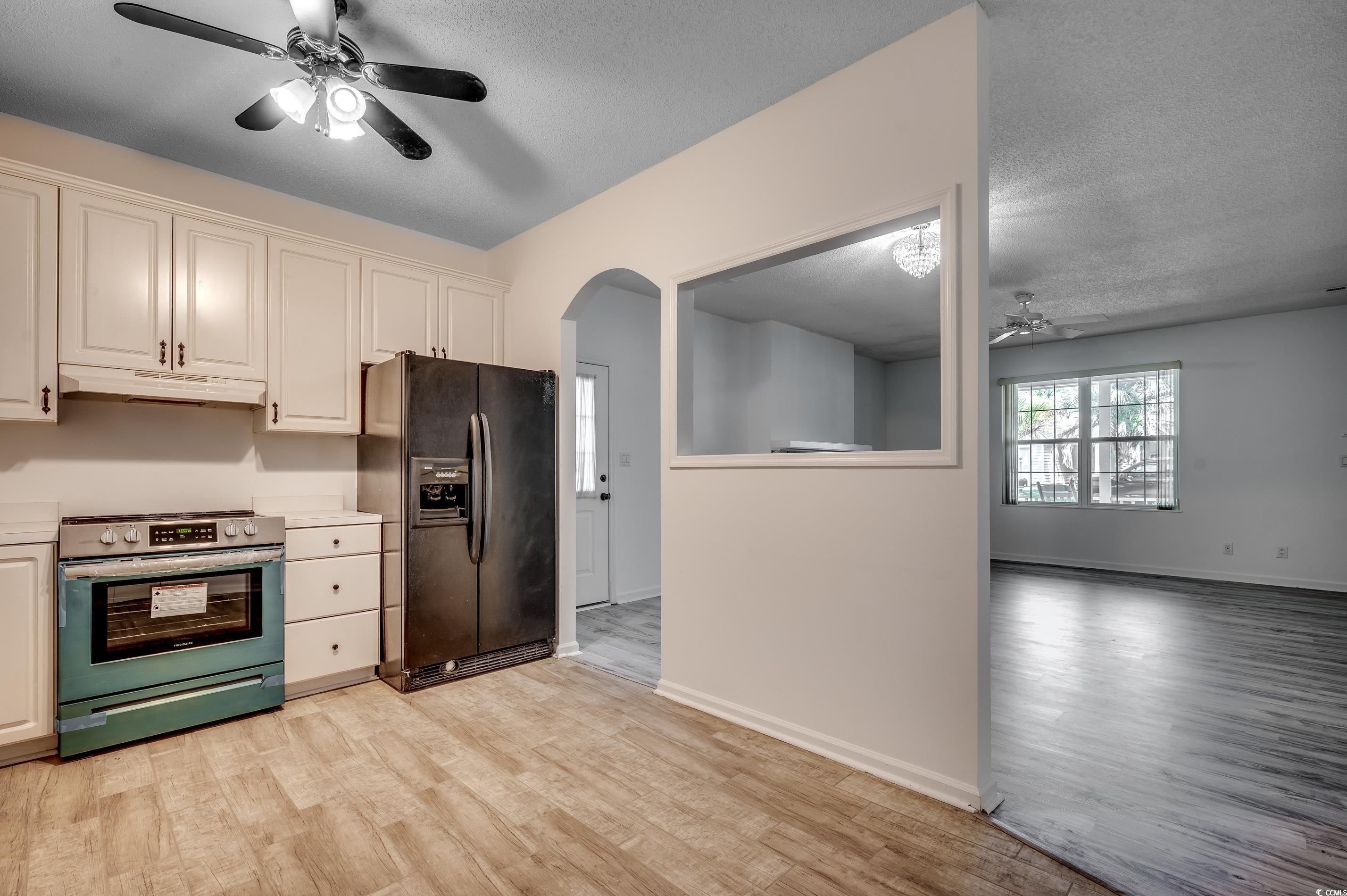 4261 Brook Drive Murrells Inlet, SC 29576 - Photo 12 of 39 Kitchen with ceiling fan, a textured ceiling, blac
