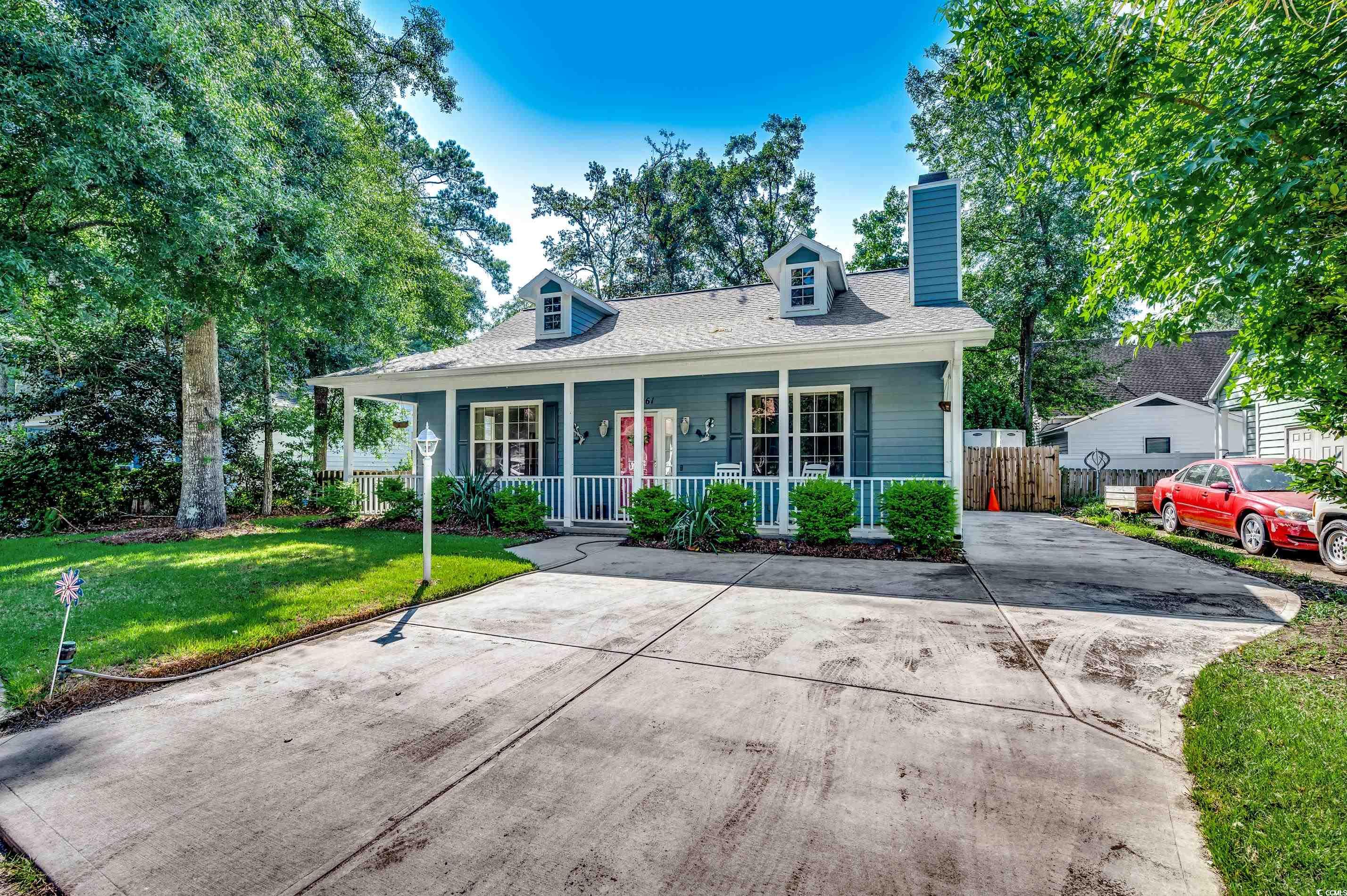4261 Brook Drive Murrells Inlet, SC 29576 - Photo 27 of 39 Cape cod-style house with a porch and a front lawn