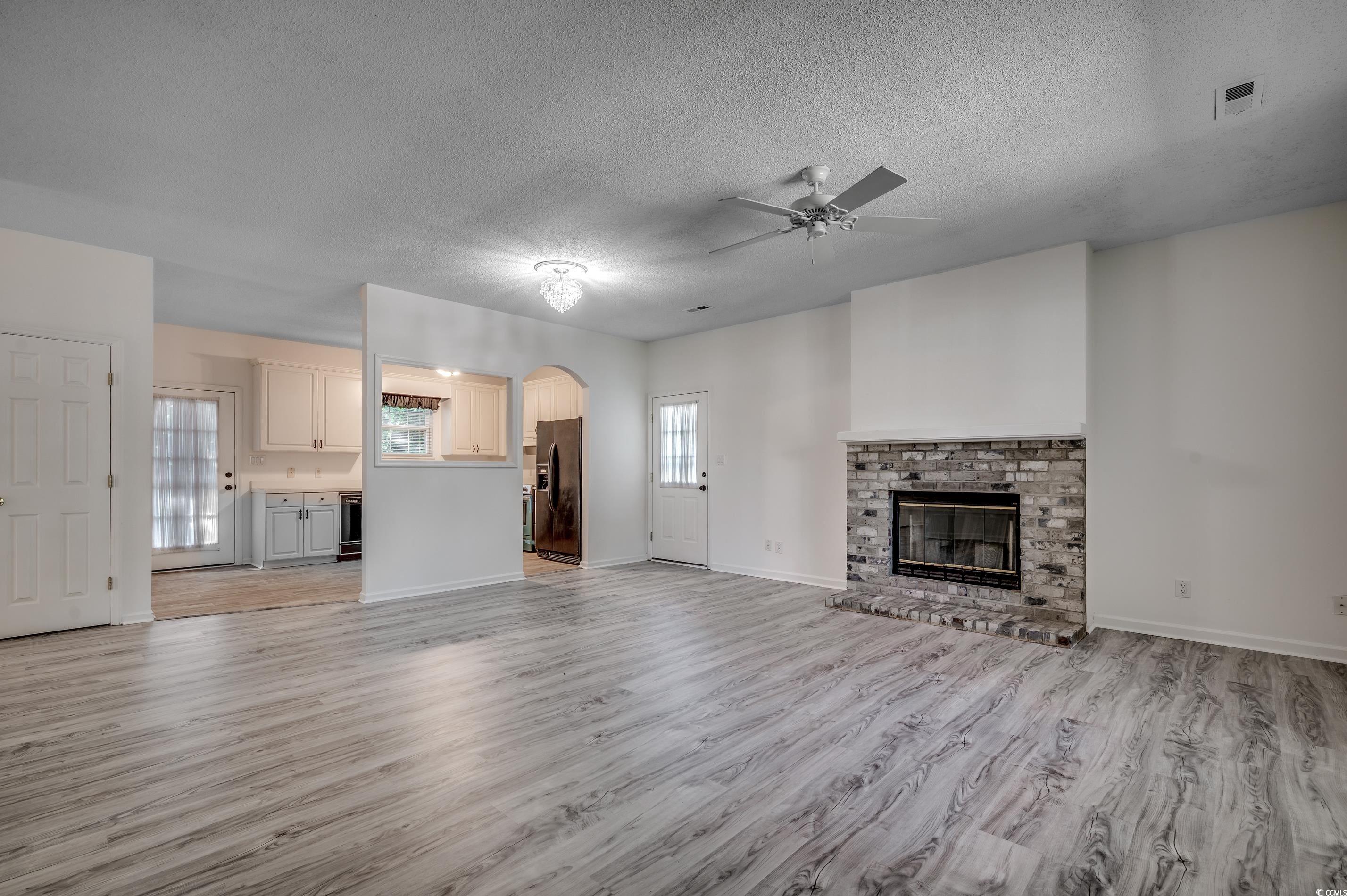 4261 Brook Drive Murrells Inlet, SC 29576 - Photo 5 of 39 Unfurnished living room with light hardwood / wood