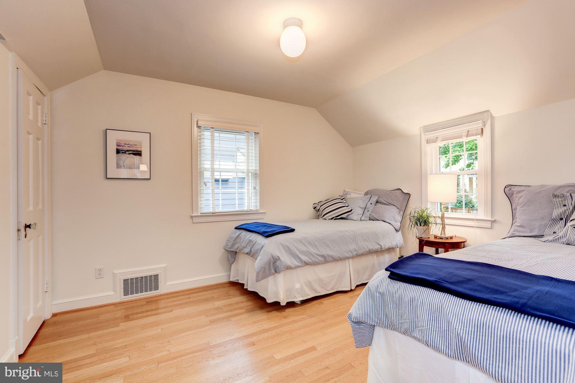 7105 Fairfax Road Bethesda, MD 20814 - Photo 11 of 17 a spacious bedroom with two beds and a window