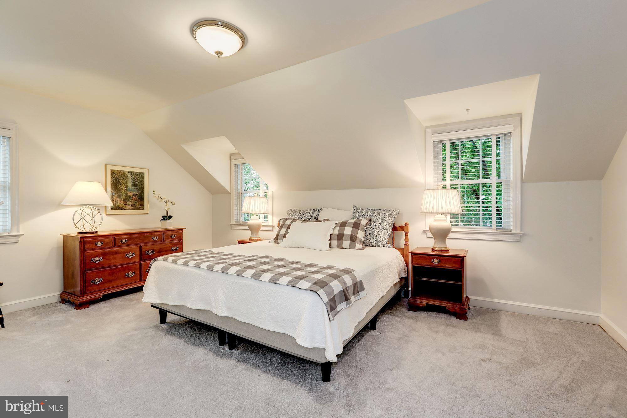 7105 Fairfax Road Bethesda, MD 20814 - Photo 12 of 17 a spacious bedroom with a bed and a window