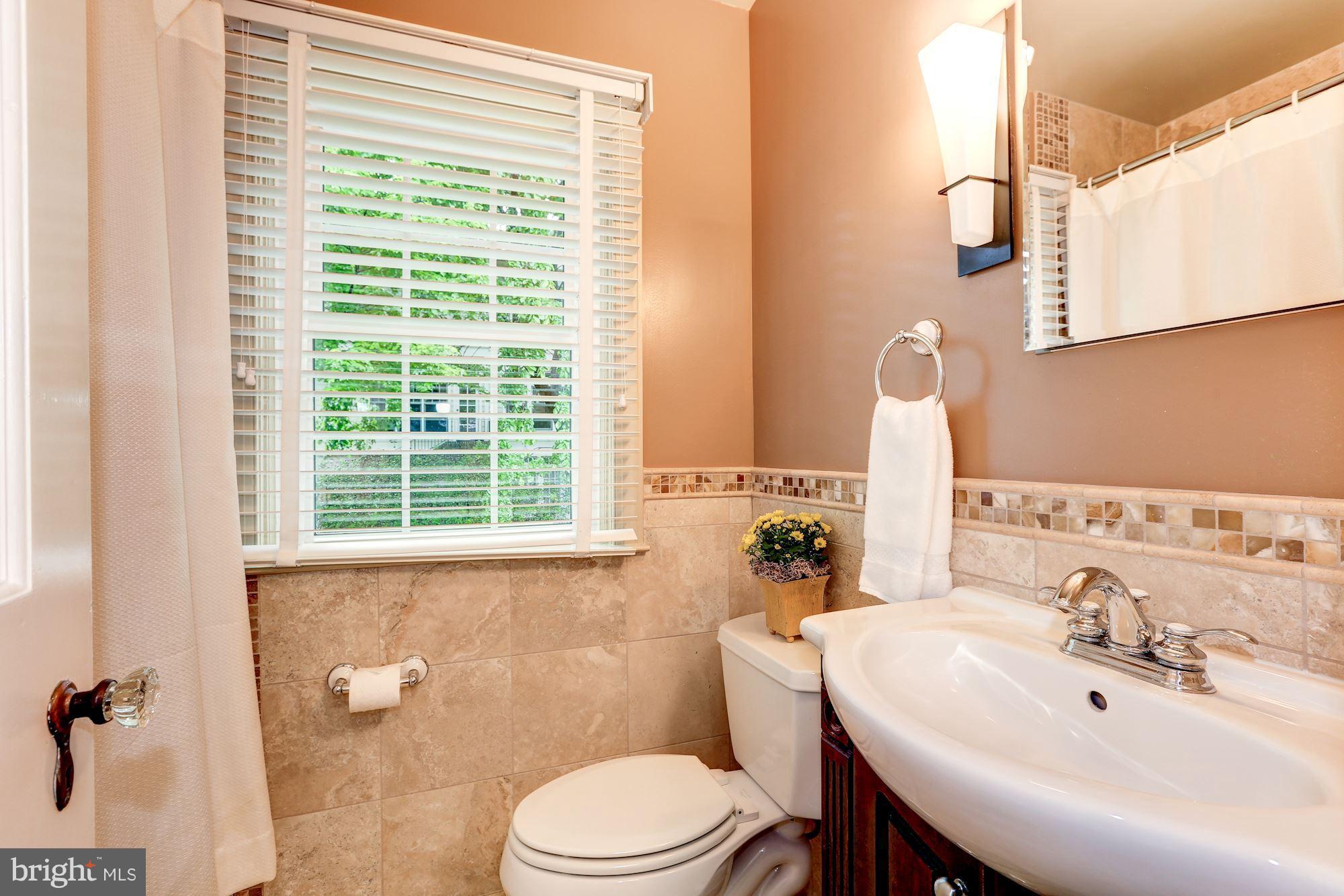 7105 Fairfax Road Bethesda, MD 20814 - Photo 14 of 17 a bathroom with a sink a toilet and tub