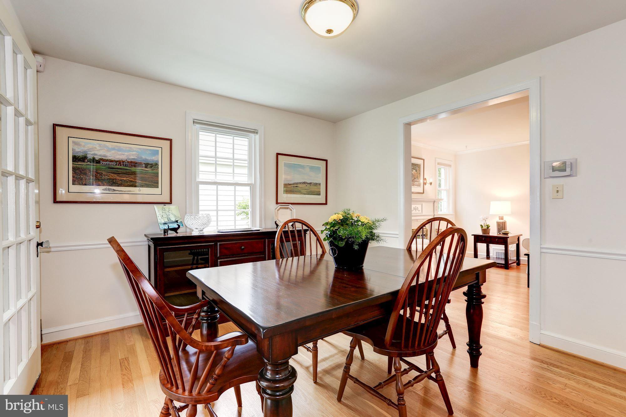 7105 Fairfax Road Bethesda, MD 20814 - Photo 5 of 17 a view of a dining room with furniture and wooden floor
