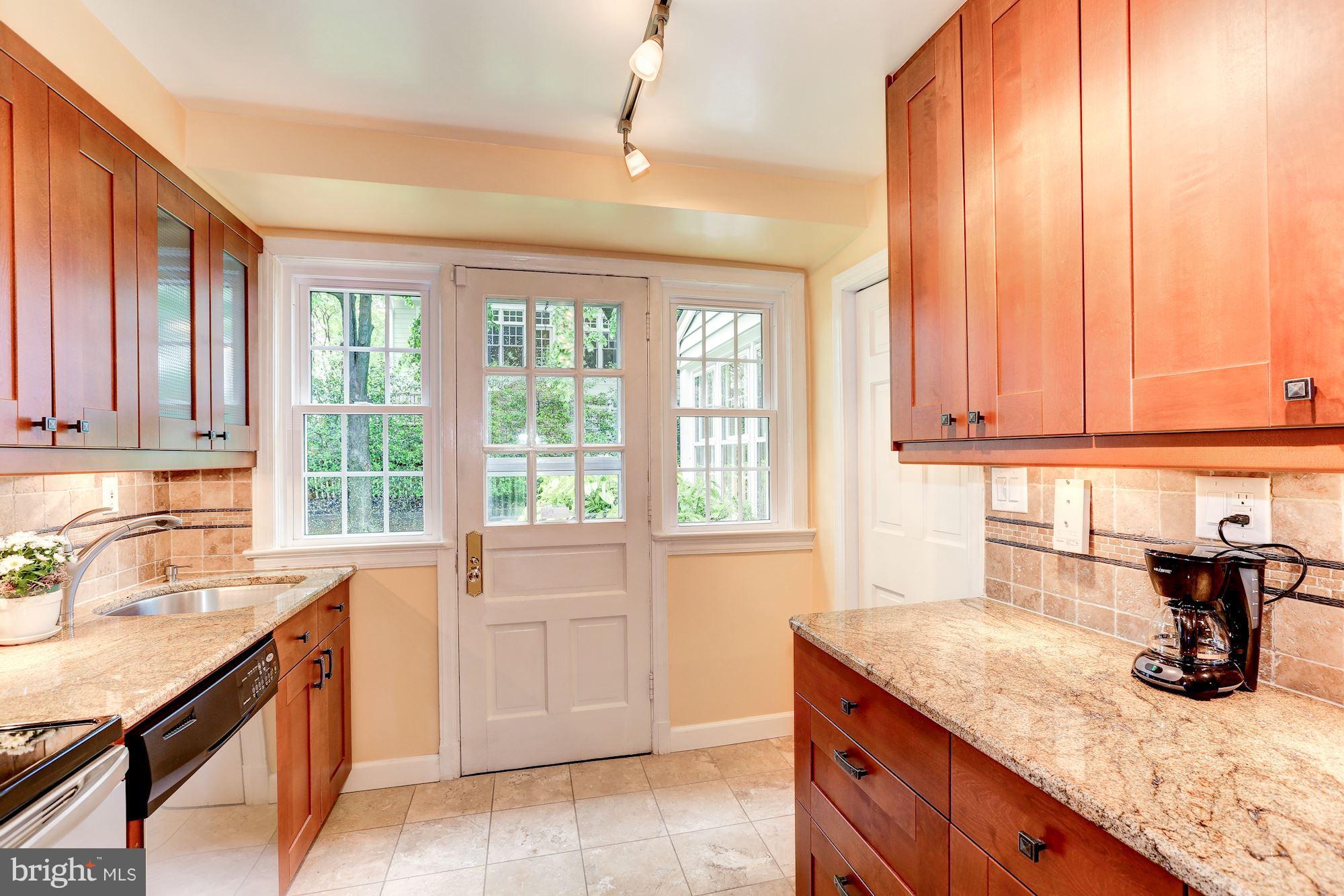 7105 Fairfax Road Bethesda, MD 20814 - Photo 8 of 17 a kitchen with granite countertop a sink and a window