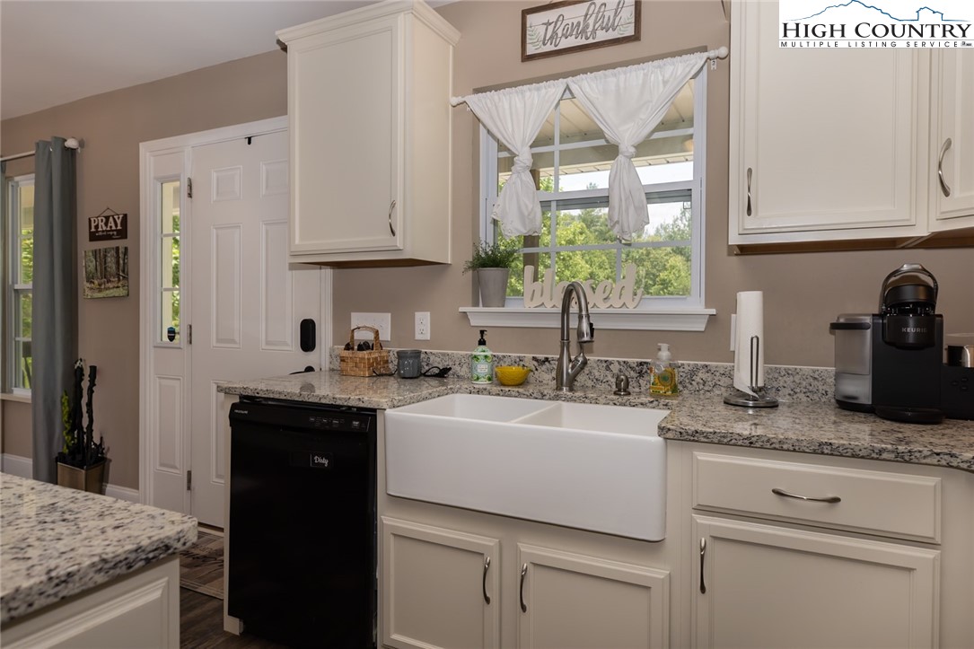 351 Colony Lane Purlear, NC 28665 - Photo 26 of 39 a kitchen with granite countertop a sink stainless steel appliances white cabinets and a granite counter tops